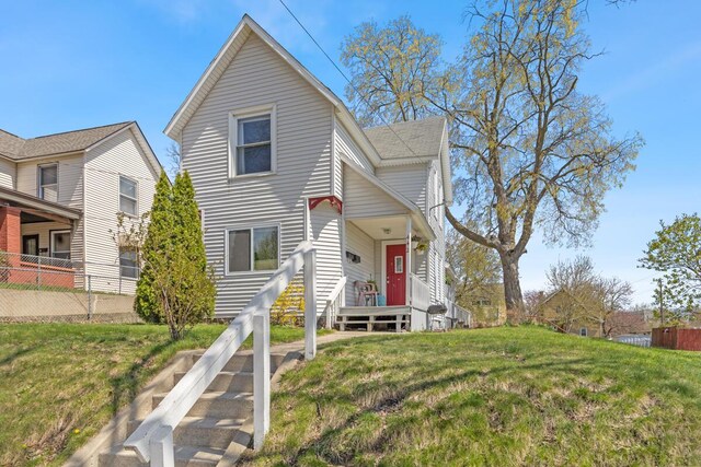 442 Emerald Ave NE, Grand Rapids, MI 49503 - traditional-style house featuring fence and a front lawn
