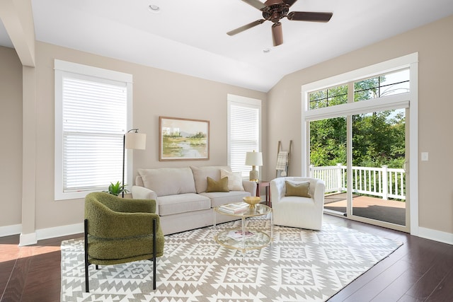 living room featuring a ceiling fan, baseboards, vaulted ceiling, and wood finished floors