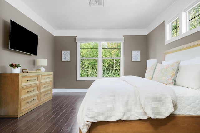 bedroom featuring baseboards, dark wood finished floors, and ornamental molding