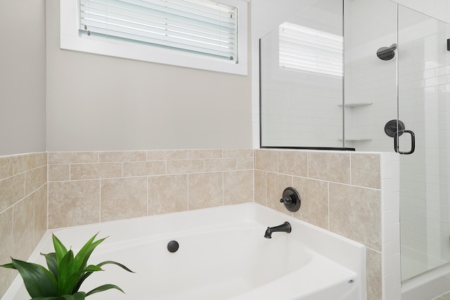 bathroom with a garden tub and a stall shower