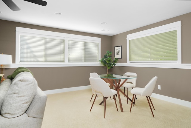 dining room featuring carpet flooring, a ceiling fan, and a wealth of natural light
