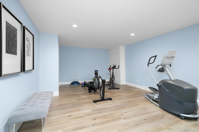 exercise room with recessed lighting, baseboards, and wood finished floors
