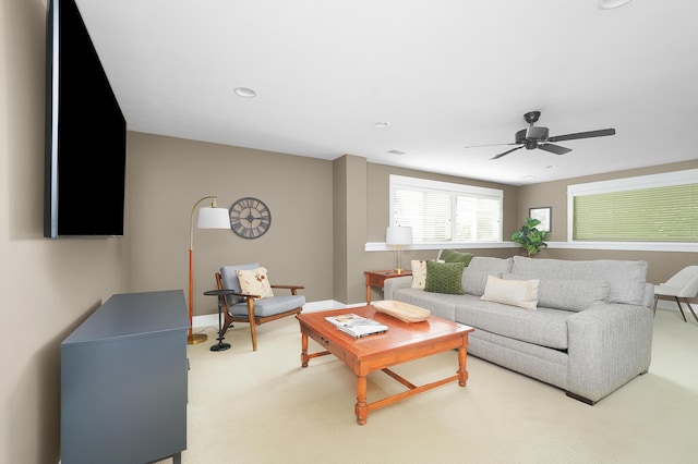 living room featuring recessed lighting, ceiling fan, light colored carpet, and baseboards