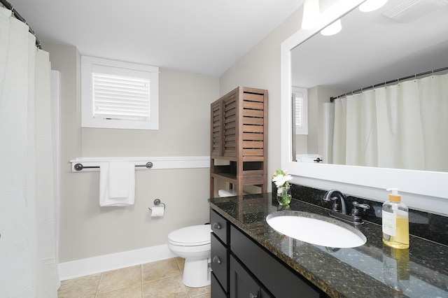 bathroom featuring tile patterned flooring, vanity, toilet, baseboards, and visible vents