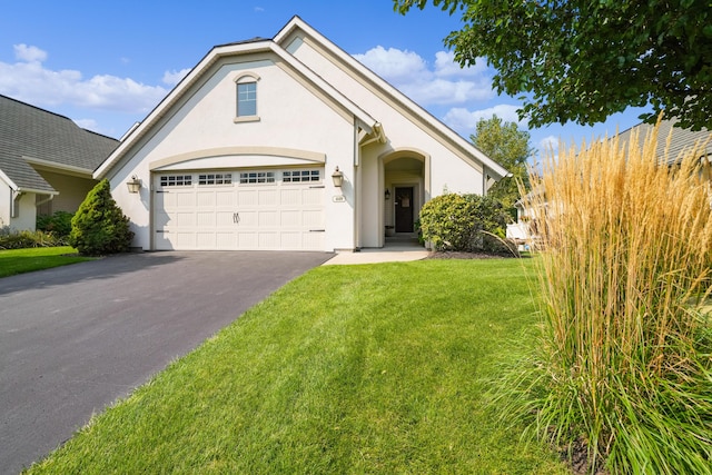 view of front of house featuring fence, stucco siding, driveway, and a front yard
