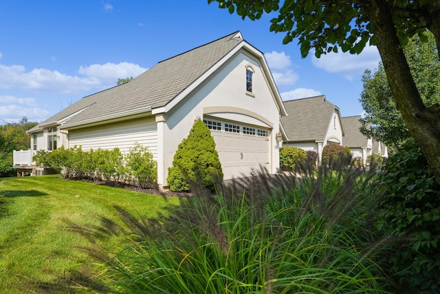 view of side of property featuring a lawn and stucco siding