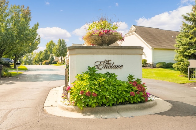 community sign featuring a lawn
