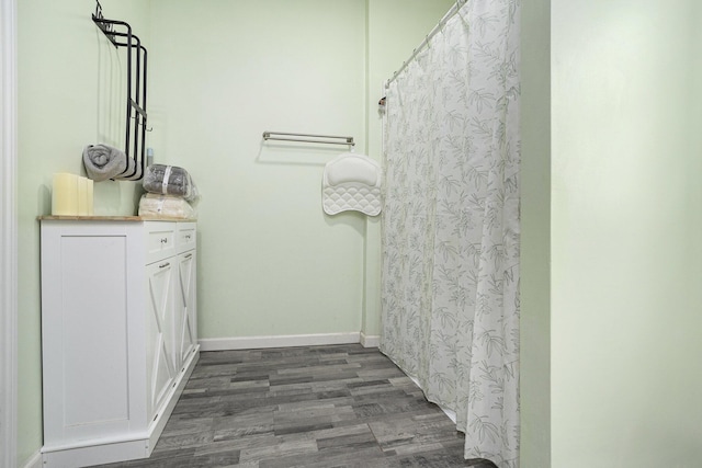 145 Kingsbury St, Athens, MI 49011 - full bath with baseboards, curtained shower, and wood finished floors