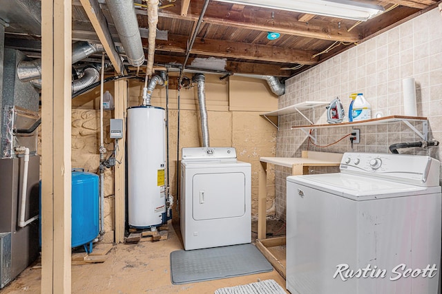 7229 Bordeau Dr NE, Belding, MI 48809 - laundry area with concrete block wall, separate washer and dryer, gas water heater, and laundry area