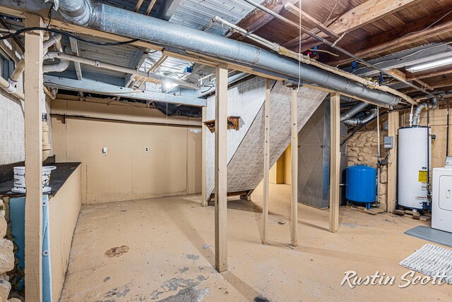 7229 Bordeau Dr NE, Belding, MI 48809 - unfinished below grade area featuring water heater and washer / clothes dryer