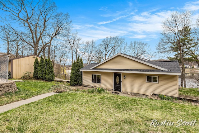 7229 Bordeau Dr NE, Belding, MI 48809 - view of front of property with a front yard, a shingled roof, and an outbuilding