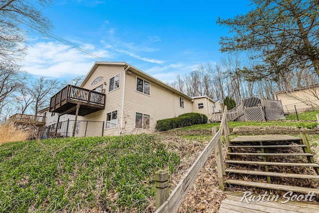 7229 Bordeau Dr NE, Belding, MI 48809 - view of side of home with a deck, stairs, and fence