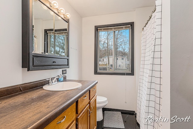 7229 Bordeau Dr NE, Belding, MI 48809 - bathroom with tile patterned flooring, a shower with curtain, toilet, vanity, and baseboards