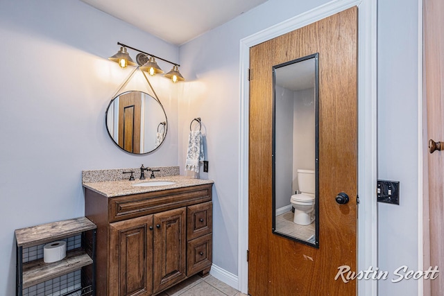 7229 Bordeau Dr NE, Belding, MI 48809 - bathroom featuring toilet, vanity, and tile patterned floors
