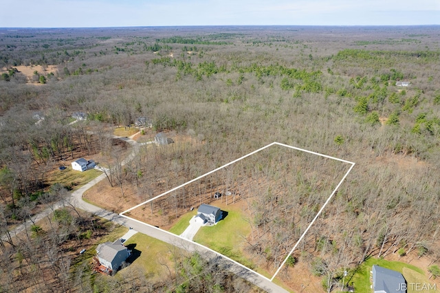 bird's eye view featuring a wooded view