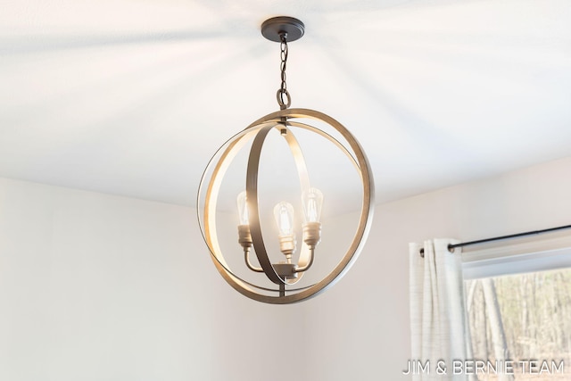 interior details featuring an inviting chandelier