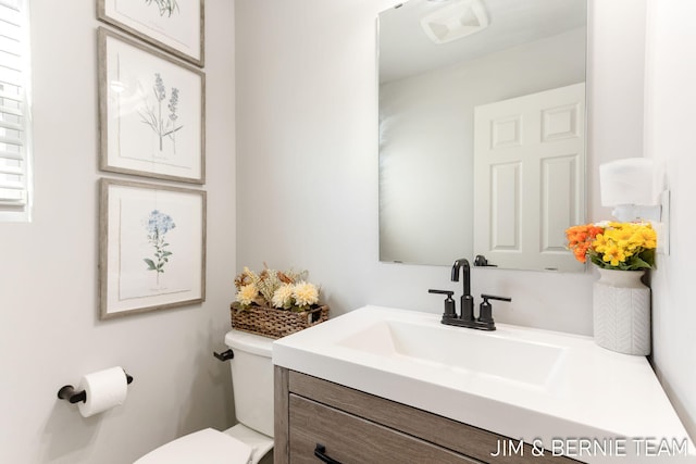 bathroom featuring toilet and vanity