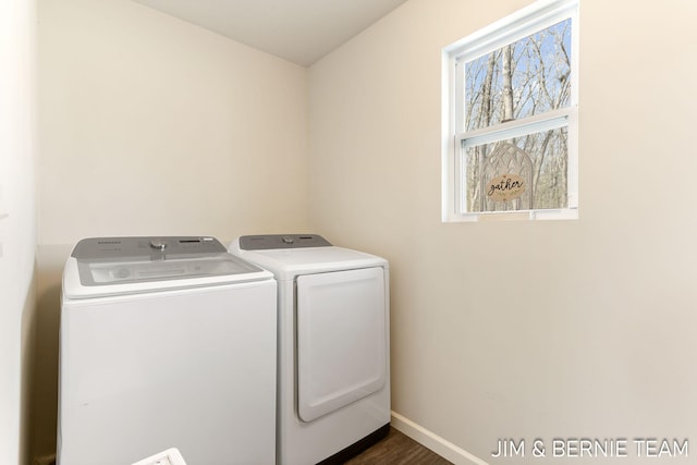 laundry area with dark wood-style floors, baseboards, washer and clothes dryer, and laundry area