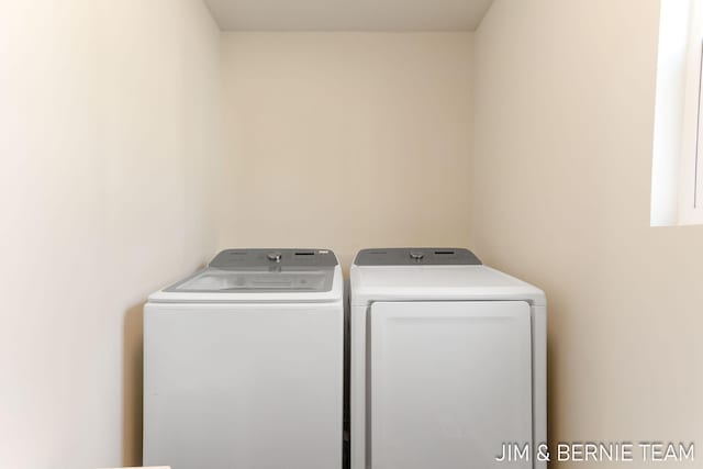 clothes washing area with washing machine and dryer and laundry area