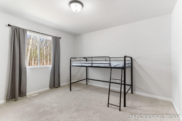 unfurnished bedroom with visible vents, baseboards, and carpet flooring