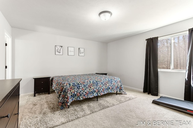 bedroom with carpet flooring and baseboards