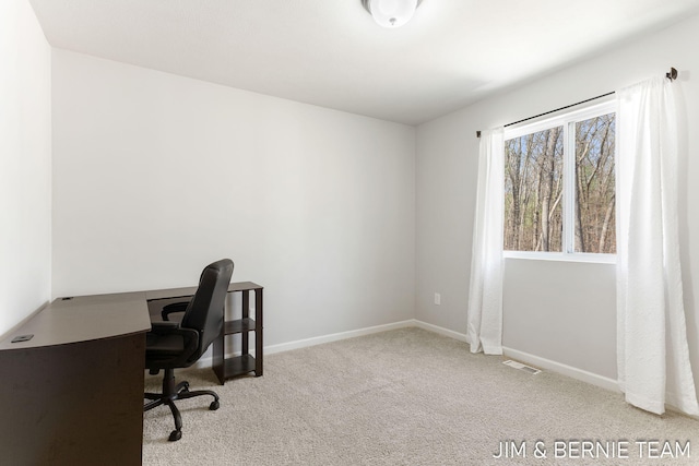 carpeted home office featuring baseboards and visible vents