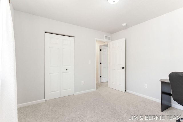 unfurnished office with baseboards, visible vents, and carpet