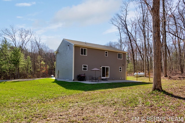 back of property with a patio area and a lawn