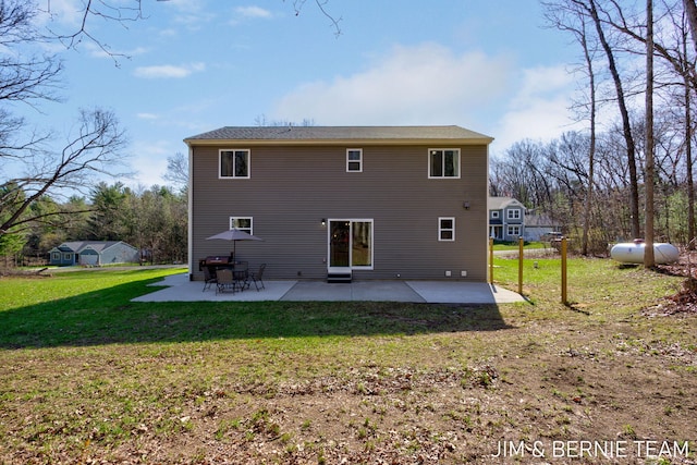 back of property with a patio area and a lawn