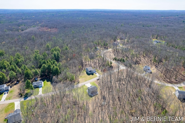 birds eye view of property featuring a wooded view
