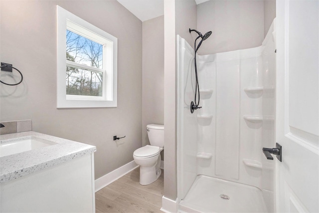 3574 Valley View Dr, Muskegon, MI 49444 - full bath featuring a walk in shower, toilet, wood finished floors, and baseboards