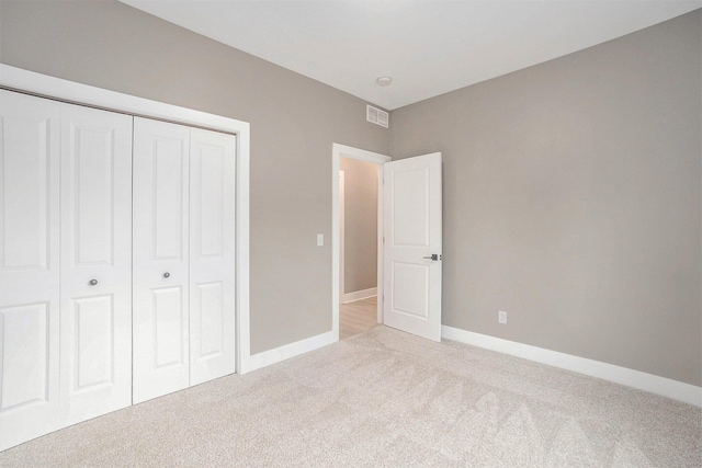 3574 Valley View Dr, Muskegon, MI 49444 - unfurnished bedroom featuring light colored carpet, a closet, and baseboards