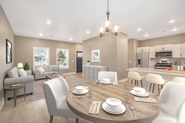 3574 Valley View Dr, Muskegon, MI 49444 - dining area featuring baseboards, a chandelier, recessed lighting, and light wood-style flooring