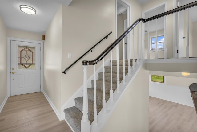 9315 Kingsley Dr, Onsted, MI 49265 - foyer entrance with light wood finished floors, stairs, and baseboards