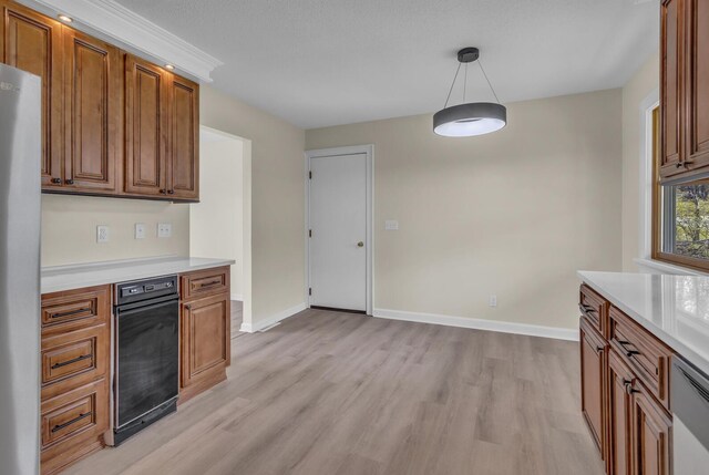 9315 Kingsley Dr, Onsted, MI 49265 - kitchen with light wood-style floors, freestanding refrigerator, brown cabinets, light countertops, and baseboards