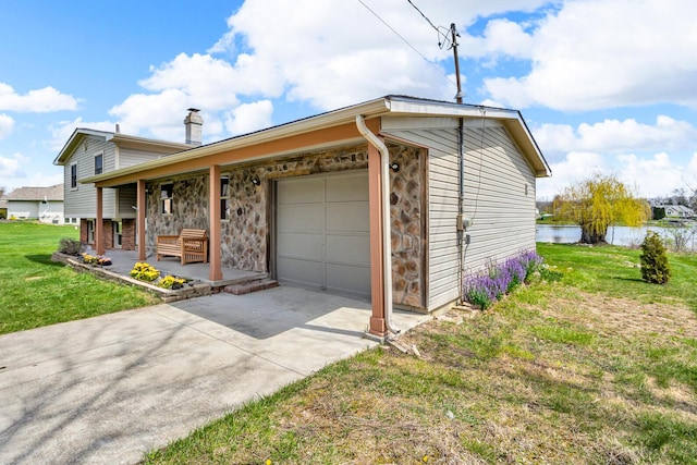 9315 Kingsley Dr, Onsted, MI 49265 - view of property exterior with an attached garage, a porch, a yard, a chimney, and driveway
