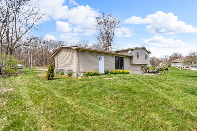 9315 Kingsley Dr, Onsted, MI 49265 - back of house featuring a yard and a patio area