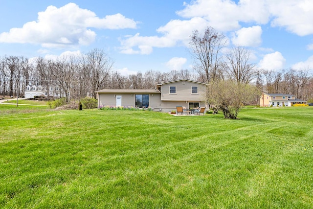 9315 Kingsley Dr, Onsted, MI 49265 - rear view of property with a lawn and a patio