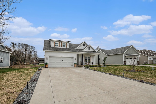 2537 Odawa Trl, Muskegon, MI 49444 - view of front of property with driveway, a porch, a front lawn, and roof with shingles
