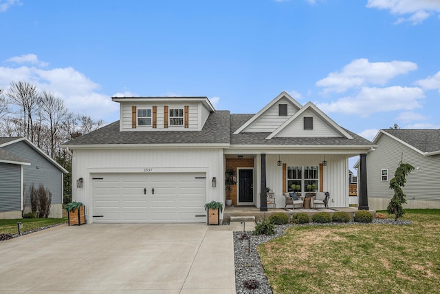 2537 Odawa Trl, Muskegon, MI 49444 - view of front facade with concrete driveway, covered porch, a front yard, a garage, and roof with shingles