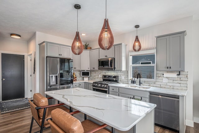 2537 Odawa Trl, Muskegon, MI 49444 - kitchen featuring tasteful backsplash, a sink, gray cabinets, dark wood finished floors, and appliances with stainless steel finishes