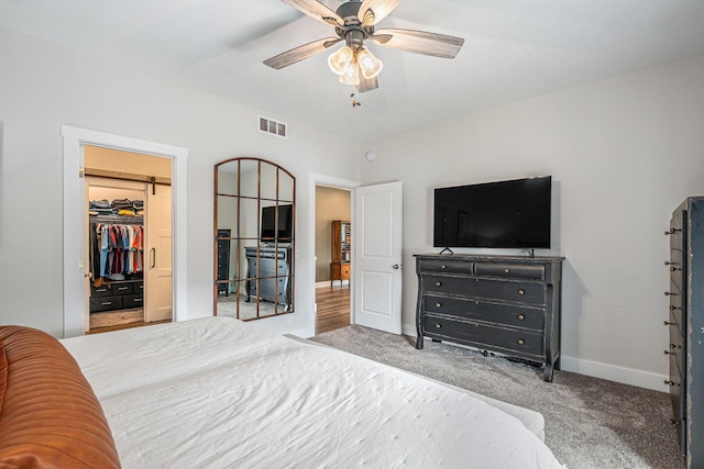 2537 Odawa Trl, Muskegon, MI 49444 - carpeted bedroom with a spacious closet, visible vents, a closet, baseboards, and ceiling fan