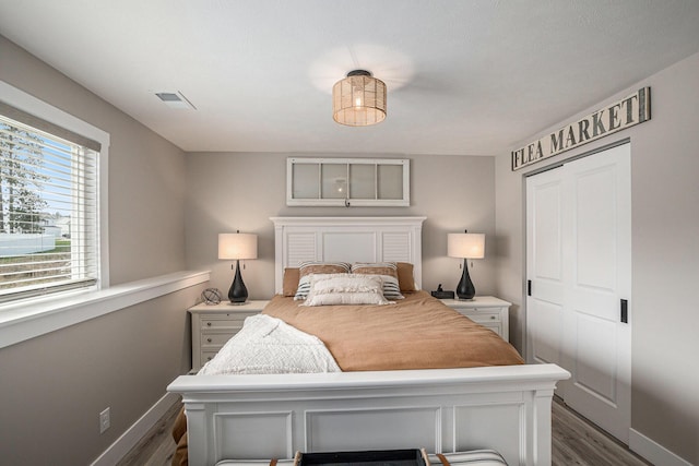 2537 Odawa Trl, Muskegon, MI 49444 - bedroom with baseboards, visible vents, a closet, and dark wood finished floors