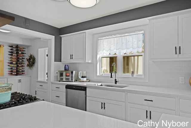 2233 Mills Ave, Muskegon, MI 49445 - kitchen with a sink, light countertops, decorative backsplash, and dishwasher