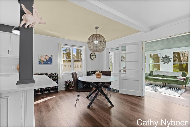 2233 Mills Ave, Muskegon, MI 49445 - dining space featuring ornamental molding, a healthy amount of sunlight, and dark wood-style floors