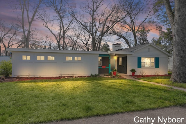 2233 Mills Ave, Muskegon, MI 49445 - ranch-style home with a chimney and a front lawn
