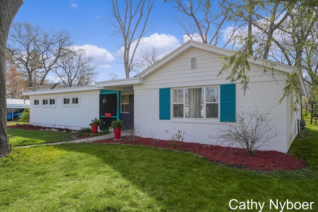 2233 Mills Ave, Muskegon, MI 49445 - ranch-style home with brick siding and a front yard