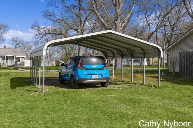2233 Mills Ave, Muskegon, MI 49445 - view of parking / parking lot featuring fence and a detached carport