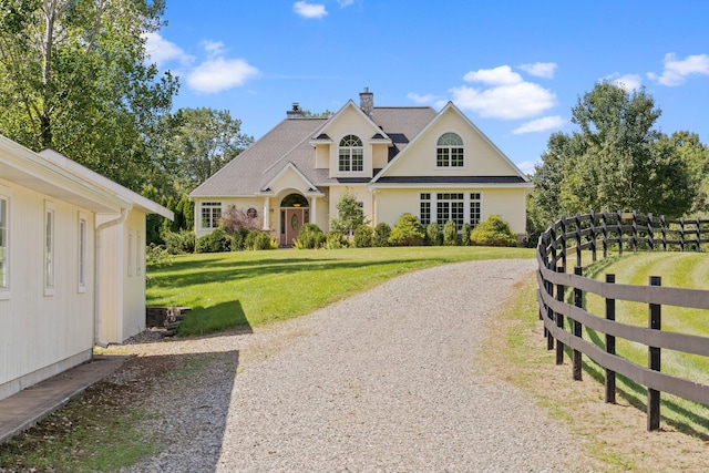 1280 Sylvan Rd, Chelsea, MI 48118 - view of front of property with fence, driveway, a chimney, and a front yard