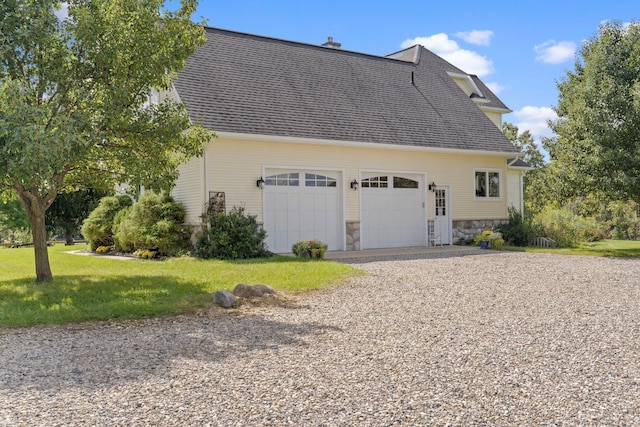 1280 Sylvan Rd, Chelsea, MI 48118 - view of side of property with stone siding, an attached garage, a shingled roof, a yard, and gravel driveway